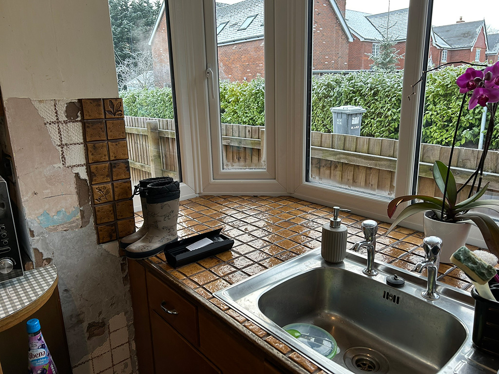 Old kitchen sink stanless steel missing wall tiles very messy