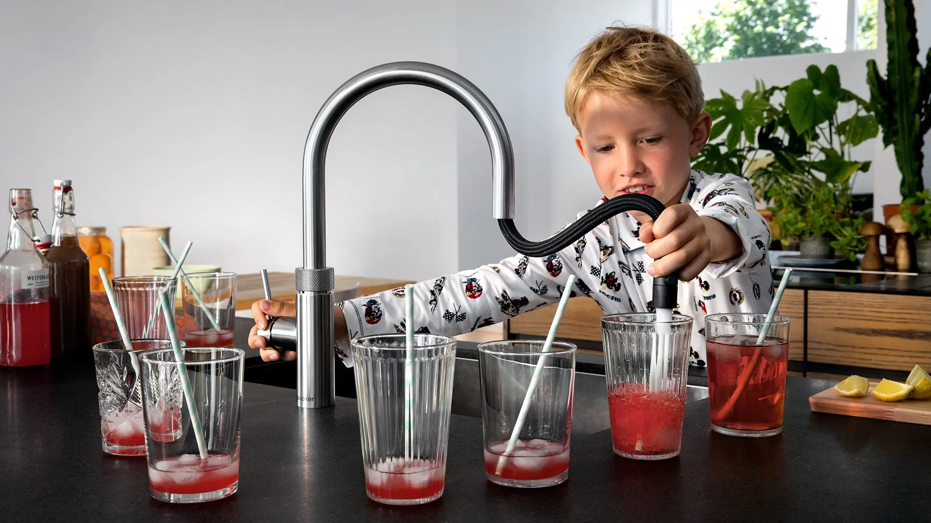 Boy using Quooker Flex RVS to make Cherry Lemonade