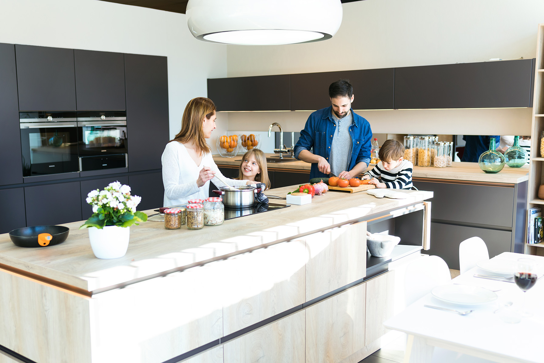 Family gathered around a kitchen island in a luxury Cheshire kitchen