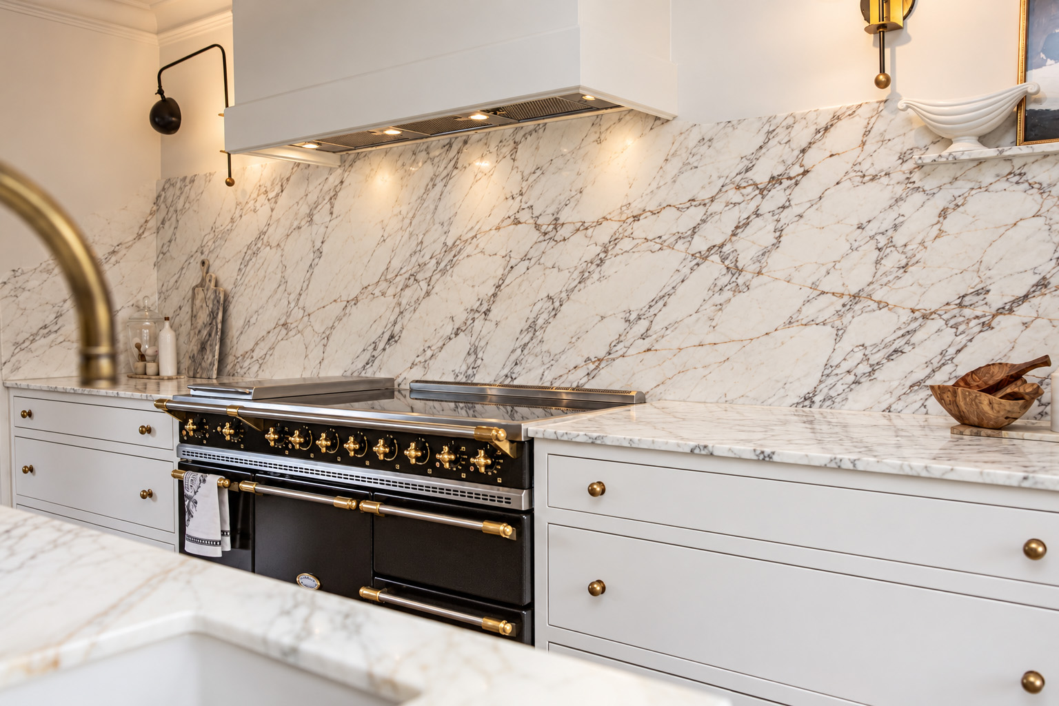 Expressive stone worktop and splashback Veined stone worktop carried up the wall as a matching splashback